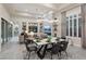 Elegant dining area with modern lighting, seating for six, and an open view into the living space at 10018 Regency Square Ave, Las Vegas, NV 89148