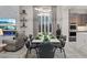 Stylish dining area open to the living room and kitchen, featuring a modern light fixture at 10018 Regency Square Ave, Las Vegas, NV 89148