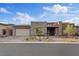 Beautiful single story home with desert landscaping, stone accents, and an attached three car garage at 10018 Regency Square Ave, Las Vegas, NV 89148