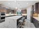 Modern kitchen featuring a large island with a white countertop and sleek, dark cabinetry at 10018 Regency Square Ave, Las Vegas, NV 89148