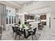 Open floor plan of a kitchen with an island and dining table with natural lighting at 10018 Regency Square Ave, Las Vegas, NV 89148