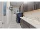 Functional laundry room features dark cabinetry, sink, and modern appliances for added convenience and efficiency at 10018 Regency Square Ave, Las Vegas, NV 89148