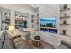 Open-concept living room featuring recessed lighting, fireplace, and display shelves at 10018 Regency Square Ave, Las Vegas, NV 89148