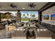 A luxurious outdoor lounge area with comfortable seating, grilling stations, and a beautiful green landscape at 10018 Regency Square Ave, Las Vegas, NV 89148