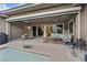 Inviting outdoor patio featuring a dining area, lounge seating, and view of the sparkling pool and garden at 10018 Regency Square Ave, Las Vegas, NV 89148