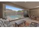 Covered patio featuring outdoor seating, a dining area, and views of the backyard pool at 10018 Regency Square Ave, Las Vegas, NV 89148