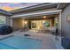 Inviting outdoor patio with dining table, seating, grill, and view of the pool, perfect for outdoor gatherings at 10018 Regency Square Ave, Las Vegas, NV 89148