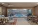 Relaxing outdoor patio with comfortable seating, dining table, ceiling fan, and view of the refreshing pool at 10018 Regency Square Ave, Las Vegas, NV 89148