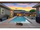 Backyard pool featuring desert landscaping, a basketball hoop, a built-in grill, and a fun alligator statue at 10018 Regency Square Ave, Las Vegas, NV 89148