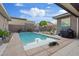 Backyard pool featuring desert landscaping, a basketball hoop, a built-in grill, and beautiful blue skies at 10018 Regency Square Ave, Las Vegas, NV 89148