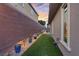 The side yard features desert landscaping and decorative rock for easy maintenance at 10018 Regency Square Ave, Las Vegas, NV 89148