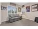 Cozy sitting room with natural light, neutral color palette, and sports memorabilia adds to the room's appeal at 10018 Regency Square Ave, Las Vegas, NV 89148