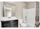 Bathroom featuring a single sink, dark cabinets, a large mirror, and a shower-tub combination at 10976 Bluebell Basin Rd, Las Vegas, NV 89179