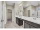 Bathroom featuring double sinks, vanity, and large mirrors at 10976 Bluebell Basin Rd, Las Vegas, NV 89179