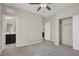 Bedroom features neutral-colored walls, carpeted floors, a ceiling fan, and an attached bathroom at 10976 Bluebell Basin Rd, Las Vegas, NV 89179