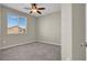 Bedroom featuring neutral-colored walls, carpeted floors, a ceiling fan, and a window with a view at 10976 Bluebell Basin Rd, Las Vegas, NV 89179
