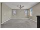 Spacious bedroom featuring carpet flooring, neutral walls, and multiple windows at 10976 Bluebell Basin Rd, Las Vegas, NV 89179