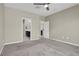 Bedroom featuring neutral walls, carpet, and entries to bathroom and closet at 10976 Bluebell Basin Rd, Las Vegas, NV 89179