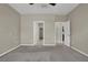 Spacious bedroom featuring neutral walls, carpet, and entries to bath and closet at 10976 Bluebell Basin Rd, Las Vegas, NV 89179