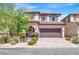 Charming two-story home featuring a tile roof, well-maintained landscaping, and a spacious two-car garage at 10976 Bluebell Basin Rd, Las Vegas, NV 89179