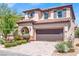 Attractive two-story home boasting a tile roof, desert landscaping, and a large two-car garage at 10976 Bluebell Basin Rd, Las Vegas, NV 89179