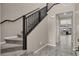 Inviting foyer with a carpeted staircase, tile flooring, and views into the open-concept living space at 10976 Bluebell Basin Rd, Las Vegas, NV 89179