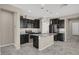 Modern kitchen with dark cabinetry, stainless steel appliances, granite countertops, and a center island at 10976 Bluebell Basin Rd, Las Vegas, NV 89179