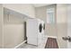 Laundry room with washer and dryer, shelf, neutral walls, and tile floors at 10976 Bluebell Basin Rd, Las Vegas, NV 89179