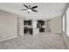 Open-concept living space featuring tile floors, ceiling fan and a modern kitchen with black cabinets at 10976 Bluebell Basin Rd, Las Vegas, NV 89179