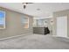 Bright loft area with carpeted floors, neutral walls, multiple windows, and a staircase at 10976 Bluebell Basin Rd, Las Vegas, NV 89179