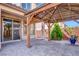 Covered patio featuring a custom wood pergola and brick floor at 10976 Bluebell Basin Rd, Las Vegas, NV 89179
