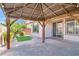 Covered patio featuring custom wood pergola and brick floor at 10976 Bluebell Basin Rd, Las Vegas, NV 89179