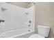 Bright bathroom features a white shower-tub combination and a toilet at 10976 Bluebell Basin Rd, Las Vegas, NV 89179