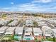 An aerial view of the neighborhood featuring new homes, community landscaping, and mountain views in the distance at 11228 Burning River St, Las Vegas, NV 89183