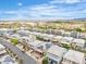 Aerial view of a modern neighborhood with mountain views, solar panels, and well-maintained landscaping at 11228 Burning River St, Las Vegas, NV 89183