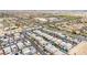 Expansive aerial view showcasing a community of modern homes with solar panels and proximity to a school at 11228 Burning River St, Las Vegas, NV 89183