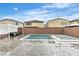 Gorgeous backyard features an in-ground pool and spa, covered patio, and perimeter block wall at 11228 Burning River St, Las Vegas, NV 89183