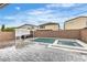 An inviting backyard includes an in-ground pool and spa, outdoor seating area, and perimeter wall at 11228 Burning River St, Las Vegas, NV 89183