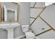 Stylish half bathroom featuring modern fixtures and a chic accent wall at 11228 Burning River St, Las Vegas, NV 89183