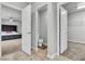 Modern bathroom with white toilet, open door, and bedroom with ceiling fan in the background at 11228 Burning River St, Las Vegas, NV 89183