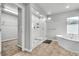 Bright bathroom featuring a luxurious soaking tub and a walk in shower at 11228 Burning River St, Las Vegas, NV 89183