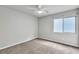 Neutral bedroom offers natural lighting from window and a ceiling fan at 11228 Burning River St, Las Vegas, NV 89183