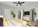 Bright bedroom featuring modern decor, a ceiling fan, and an en-suite bathroom at 11228 Burning River St, Las Vegas, NV 89183