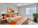 Stylishly furnished bedroom with orange accents and modern decor at 11228 Burning River St, Las Vegas, NV 89183