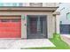 An entrance featuring a red garage door and a metal gate at 11228 Burning River St, Las Vegas, NV 89183