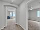 Hallway view into carpeted bedroom and living area, offering modern home design and neutral color palette at 11228 Burning River St, Las Vegas, NV 89183