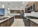 Kitchen with stainless steel appliances and granite countertops, adjoins dining and living spaces at 11228 Burning River St, Las Vegas, NV 89183