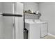 Bright laundry area features stainless steel fridge and new washer and dryer at 11228 Burning River St, Las Vegas, NV 89183
