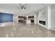 Open-concept living room with tile floors, modern fireplace, and eat-in kitchen with granite countertops at 11228 Burning River St, Las Vegas, NV 89183