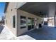 Large covered patio with ceiling fan and grey paver flooring with views into the backyard at 11228 Burning River St, Las Vegas, NV 89183